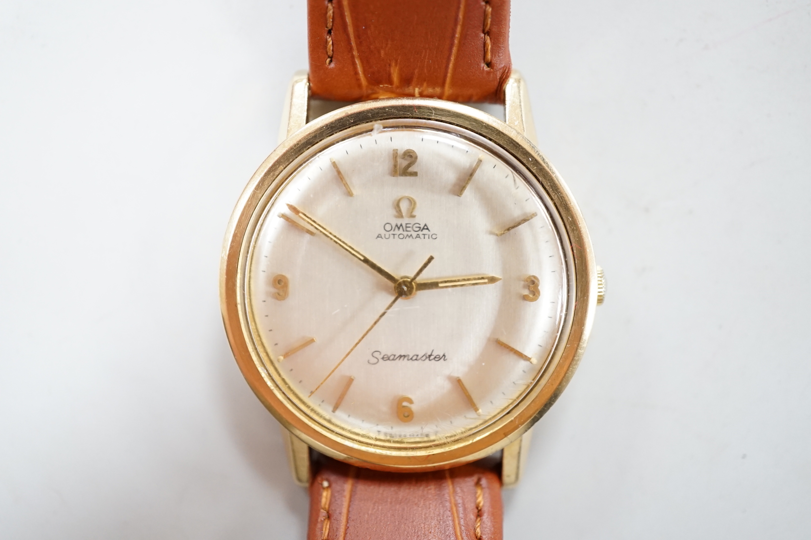 A gentleman's mid 1960's 9ct gold Omega Seamaster automatic wrist watch, movement c.552 on later associated strap, case diameter 35mm, with Omega box.